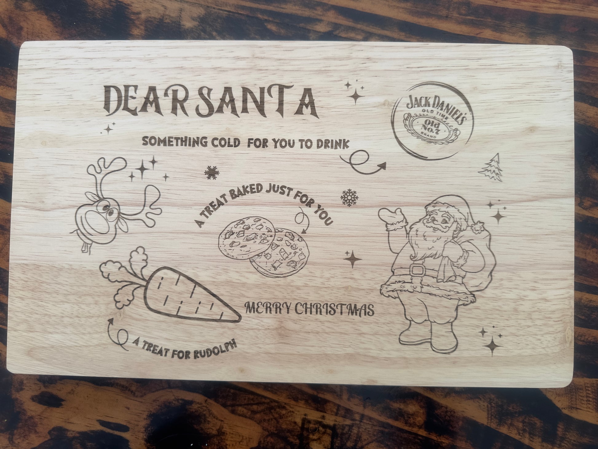 Wooden cutting board with Christmas-themed design and Jack Daniel's branding.